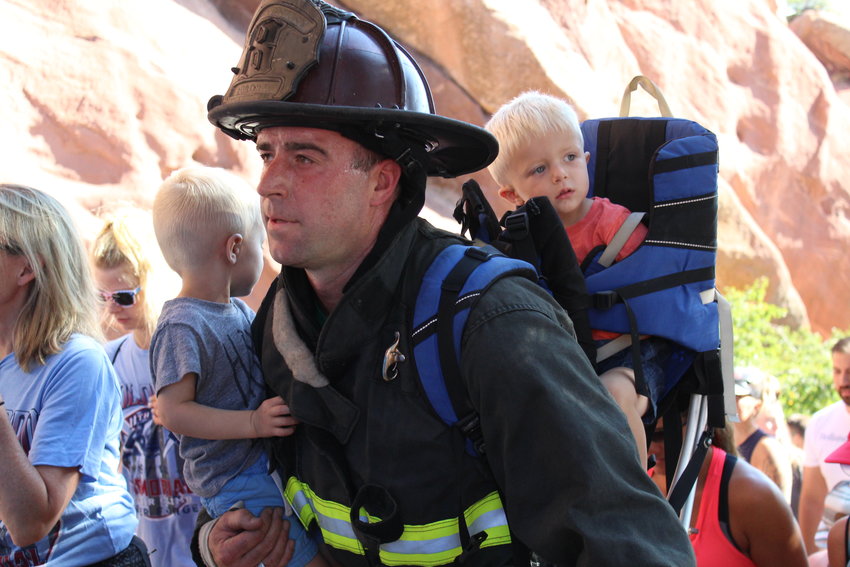 Dan Toomey of the Aurora Fire Department climbs with his twin sons Brody and Braxton. The event was held to pay tribute to the 343 FDNY firefighters and the nearly 3,000 Americans who died on 9/11.
